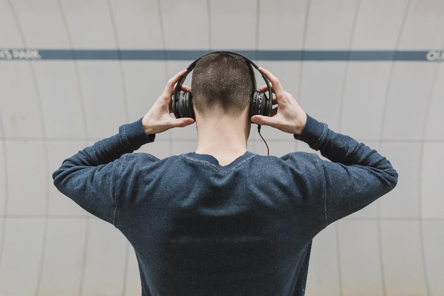 listening-to-music-back-view-guy-with-headphones